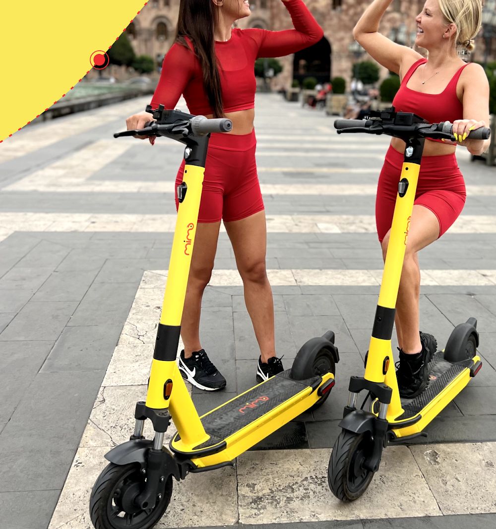 Two riders with Mimo electric scooters at Republic Square, Yerevan